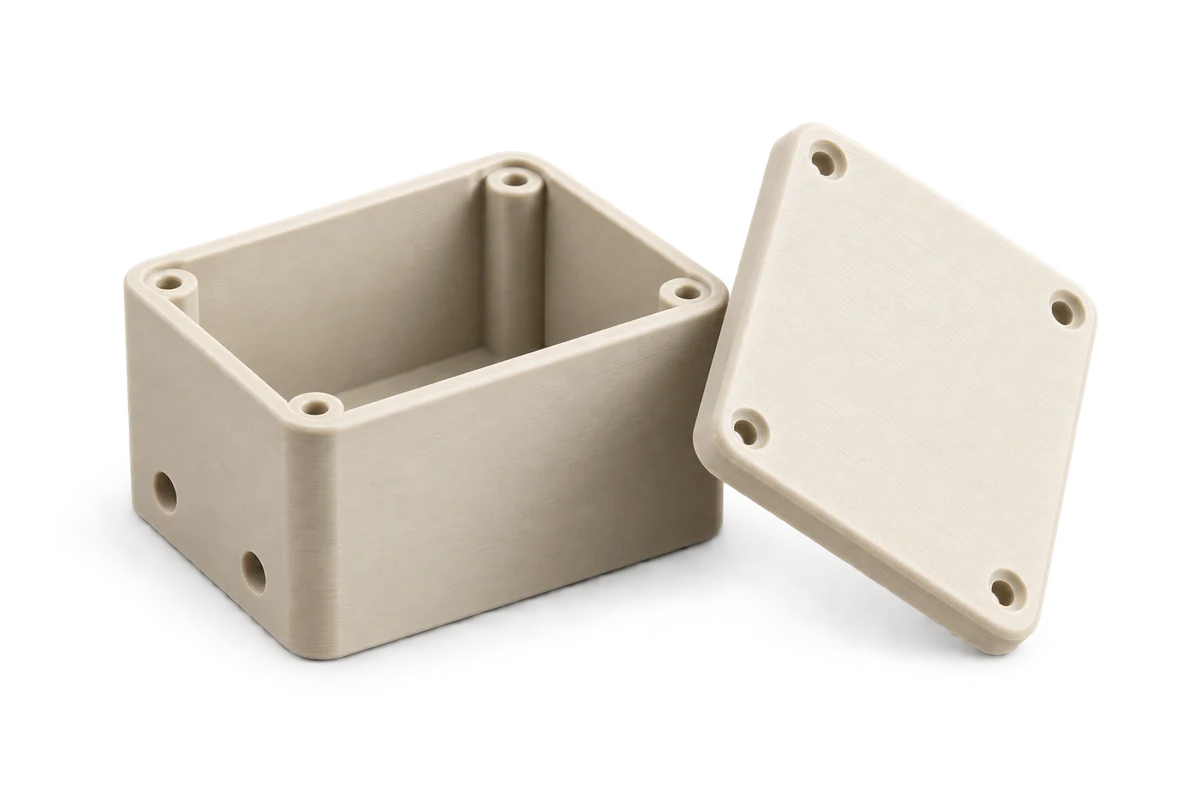 Illustrative ivory prototype enclosure with its matching lid.